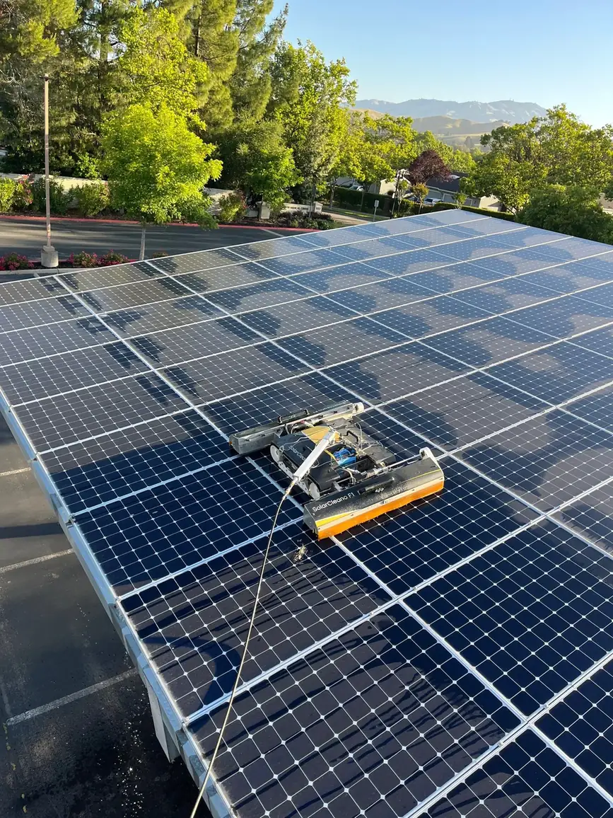 SolarCleano F1 robotic cleaner working across a carport array at a Danville medical office, Mount Diablo in the background
